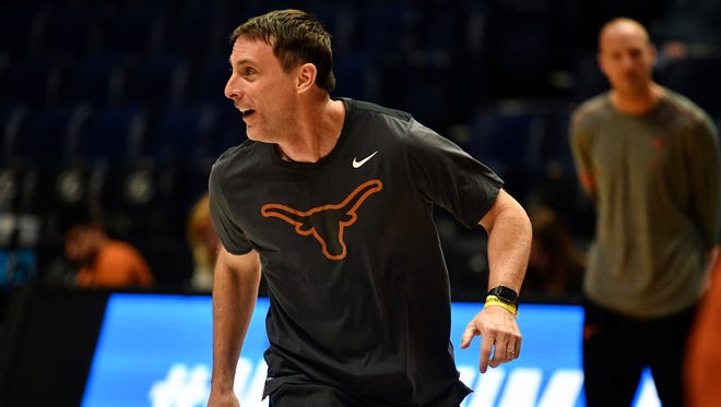 Texas assistant coach Darrin Horn runs with his team during a practice session Thursday at Bridgestone Arena.