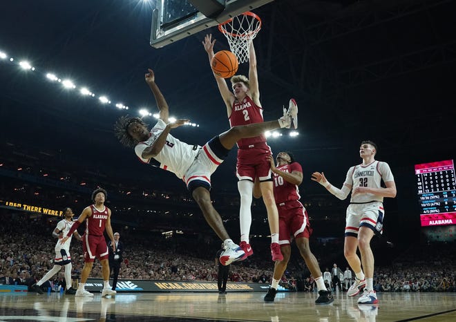 Apr 6, 2024; Glendale, AZ, USA; Connecticut Huskies guard Tristen Newton (2) loses the ball as he drives against Alabama Crimson Tide forward Grant Nelson (2) in the semifinals of the men's Final Four of the 2024 NCAA Tournament at State Farm Stadium. Mandatory Credit: Robert Deutsch-USA TODAY Sports