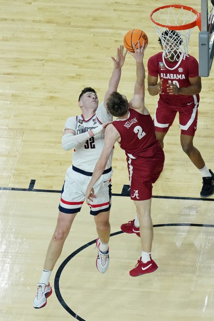 Apr 6, 2024; Glendale, AZ, USA; Alabama Crimson Tide forward Grant Nelson (2) shoots the ball against Connecticut Huskies center Donovan Clingan (32) during the second half in the semifinals of the men's Final Four of the 2024 NCAA Tournament at State Farm Stadium. Mandatory Credit: Bob Donnan-USA TODAY Sports