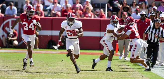 Apr 13, 2024; Tuscaloosa, AL, USA; Alabama running back Jam Miller (26) runs the ball during the A-Day game at Bryant-Denny Stadium. He is pursued by Alabama defensive back Terrance Howard (34). Mandatory Credit: Gary Cosby Jr.-USA TODAY Sports