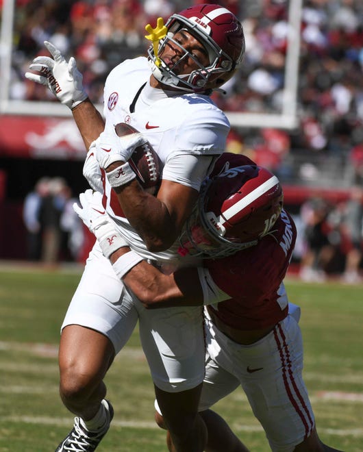 Apr 13, 2024; Tuscaloosa, AL, USA; Alabama wide receiver Caleb Odom (18) is hit and tackled by Alabama defensive back Red Morgan (16) during the A-Day scrimmage at Bryant-Denny Stadium. Mandatory Credit: Gary Cosby Jr.-USA TODAY Sports