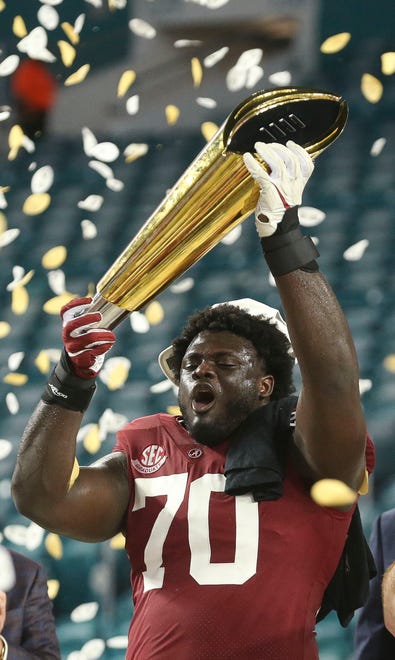 Jan 11, 2021; Miami Gardens, Florida, USA;  Alabama offensive lineman Alex Leatherwood (70) holds the championship trophy after Alabama defeated Ohio State 52-24 to win the College Football Playoff National Championship Game in Hard Rock Stadium. Mandatory Credit: Gary Cosby-USA TODAY Sports