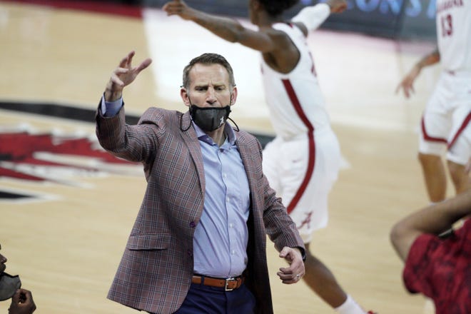 Alabama head coach Nate Oats communicates with players during the first half of an NCAA college basketball game against South Carolina Tuesday, Feb. 9, 2021, in Columbia, S.C. (AP Photo/Sean Rayford)