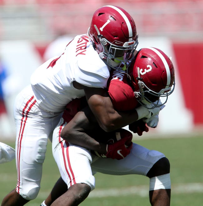 Apr 17, 2021; Tuscaloosa, Alabama, USA; White defensive back Ga'Quincy McKinstry (1) attempts a tackle of Crimson receiver Xavier Williams (3) during the University of Alabama A-Day Game at Bryant-Denny Stadium. Mandatory Credit: Gary Cosby-USA TODAY Sports