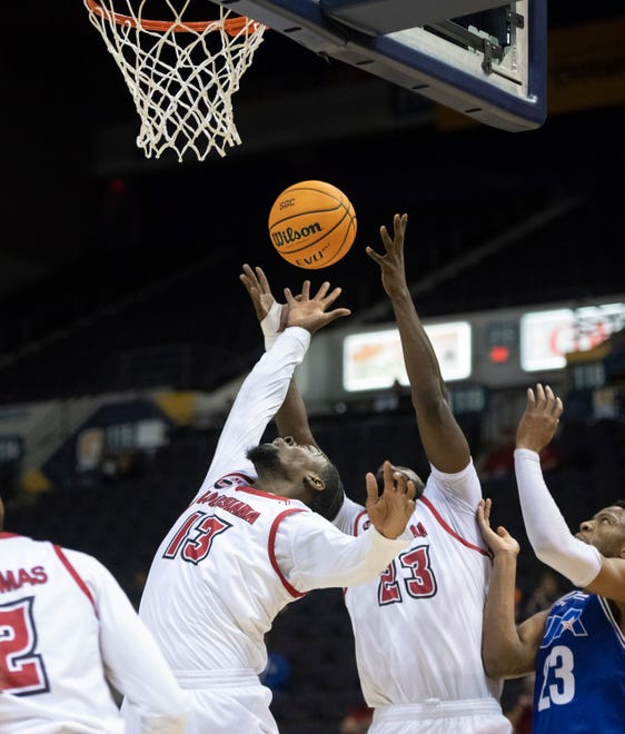 Greg Williams Jr. (13) and Dou Gueye (23) reach for the rebound during the University of Texas at Arlington vs. Louisiana men’s basketball game in the first round of the Sun Belt Conference championship tournament at the Pensacola Bay Center in Pensacola on Thursday, March 3, 2022.