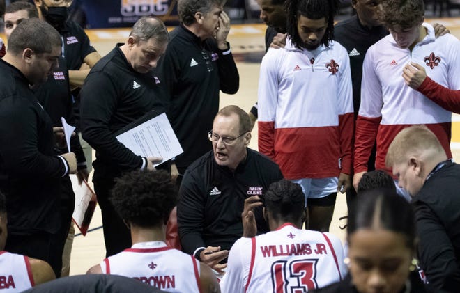 Ragin Cajuns head coach Bob Marlin, center, talks with his team during a timeout in the University of Texas at Arlington vs. Louisiana men’s basketball game in the first round of the Sun Belt Conference championship tournament at the Pensacola Bay Center in Pensacola on Thursday, March 3, 2022.