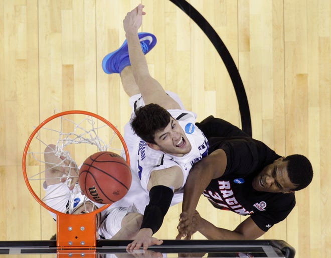 Louisiana-Lafayette's Kevin Brown (31) scores around Creighton's Will Artino, left, during the second half of a second-round game in the NCAA college basketball tournament Friday, March 21, 2014, in San Antonio. (AP Photo/Eric Gay)